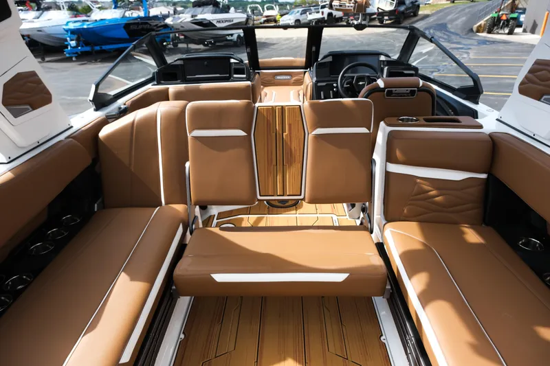 Slide: The Image of 2026 Supra SL boat interior with luxurious brown seating and modern dashboard design. - 38