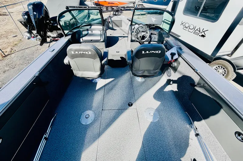 Slide: The Image of 2026 Lund 2075 Fisherman boat interior with dual seats and steering console. - 11