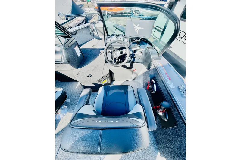 Slide: The Image of 2026 Lund 2075 Fisherman boat interior with steering wheel and seating. - 13