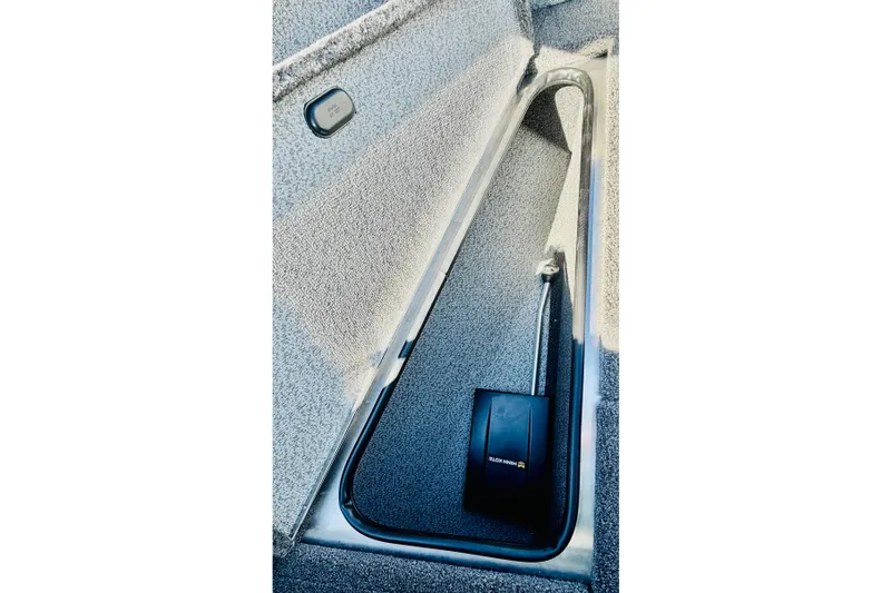 Slide: The Image of Interior view of 2026 Lund 2075 Fisherman boat, featuring a sleek storage compartment. - 16