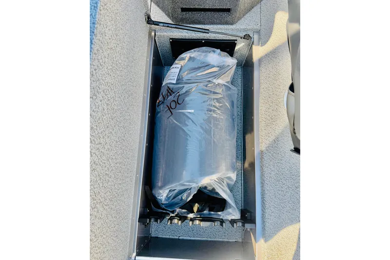 Slide: The Image of Storage compartment in 2026 Lund 2075 Fisherman boat, containing a wrapped item. - 19