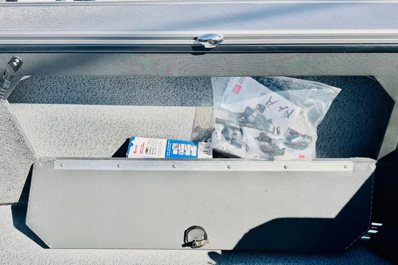 Slide: The Image of Storage compartment in 2026 Lund 2075 Fisherman boat with accessories and manuals. - 21