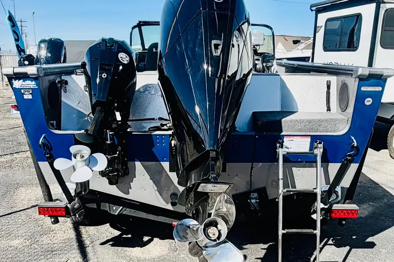 Slide: The Image of 2026 Lund 2075 Fisherman boat with dual outboard motors and ladder, rear view. - 4