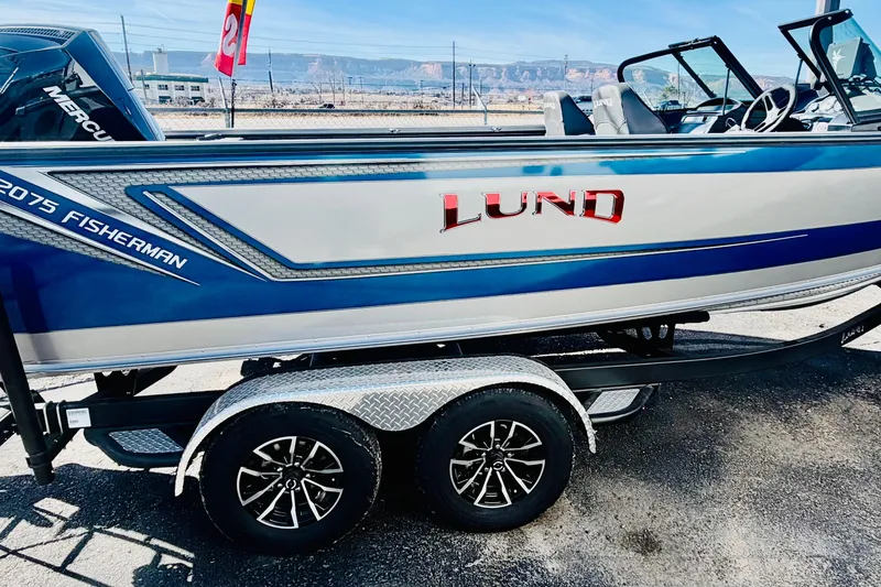 Slide: The Image of 2026 Lund 2075 Fisherman boat on trailer, featuring sleek design and vibrant colors. - 6