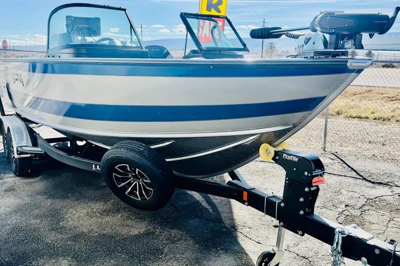 Slide: The Image of 2026 Lund 2075 Fisherman boat on trailer, displayed outdoors. - 7