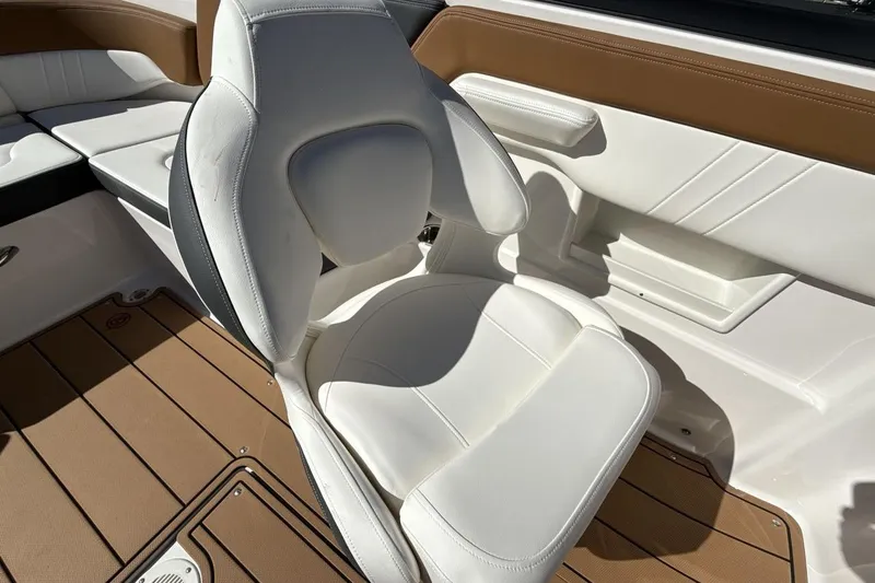 Slide: The Image of 2025 Chaparral 23 SSi boat interior with white and brown seating. - 17