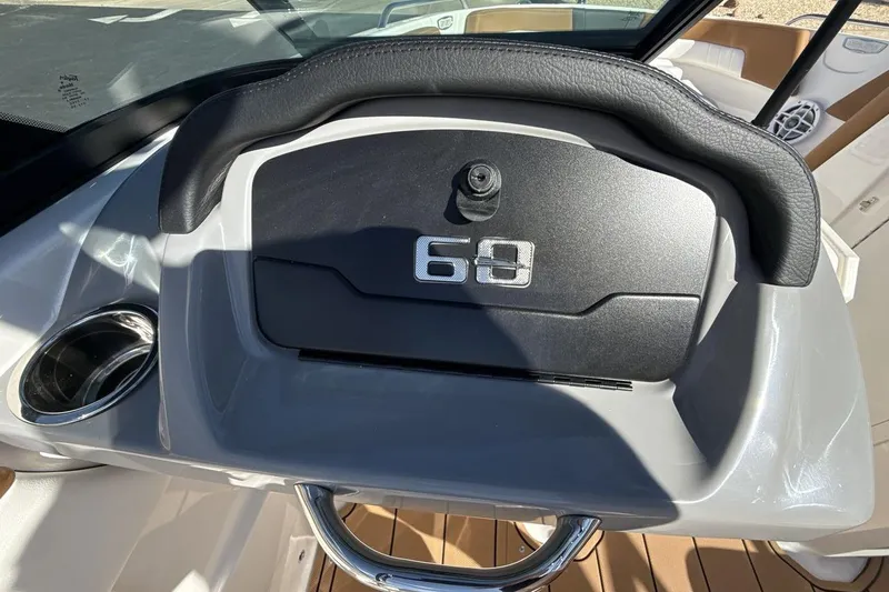 Slide: The Image of 2025 Chaparral 23 SSi dashboard with cup holder and sleek design. - 18