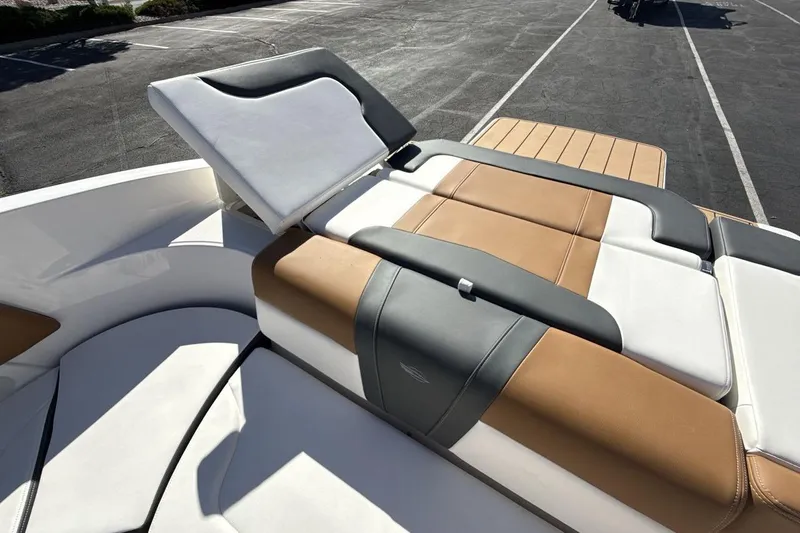 Slide: The Image of 2025 Chaparral 23 SSi boat interior with adjustable tan and white seating. - 21