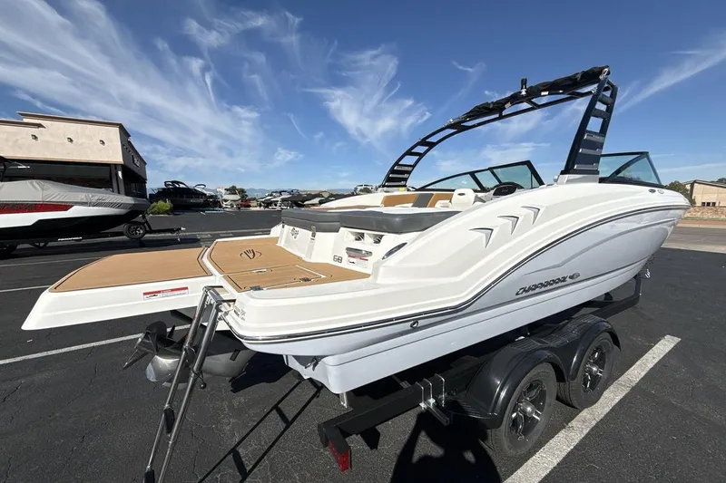 Slide: The Image of 2025 Chaparral 23 SSi boat on trailer, sleek design, sunny day, outdoor display. - 5