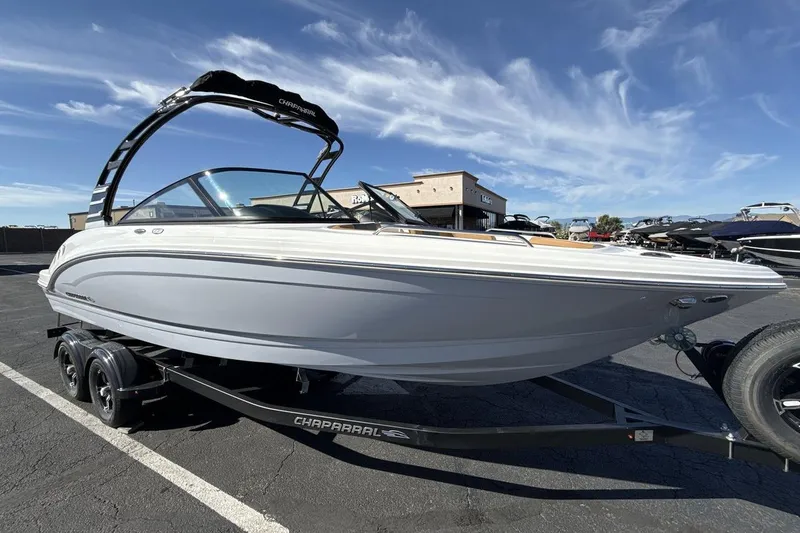 Slide: The Image of 2025 Chaparral 23 SSi boat on trailer under clear blue sky. - 7