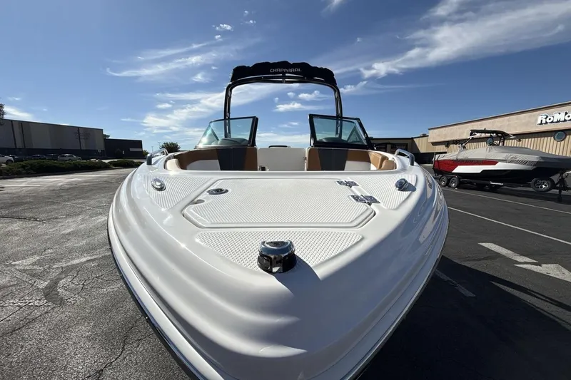 Slide: The Image of 2025 Chaparral 23 SSi boat with sleek design, parked outdoors under a clear sky. - 8