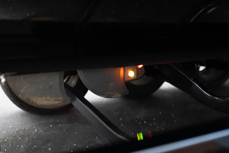 Slide: The Image of 2024 Supra SE undercarriage with illuminated sensors and wheels visible. - 13