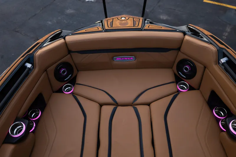 Slide: The Image of 2024 Supra SE boat interior with tan seating, black accents, and illuminated cup holders. - 16