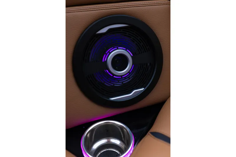 Slide: The Image of 2024 Supra SE interior speaker with ambient lighting and cup holder. - 18