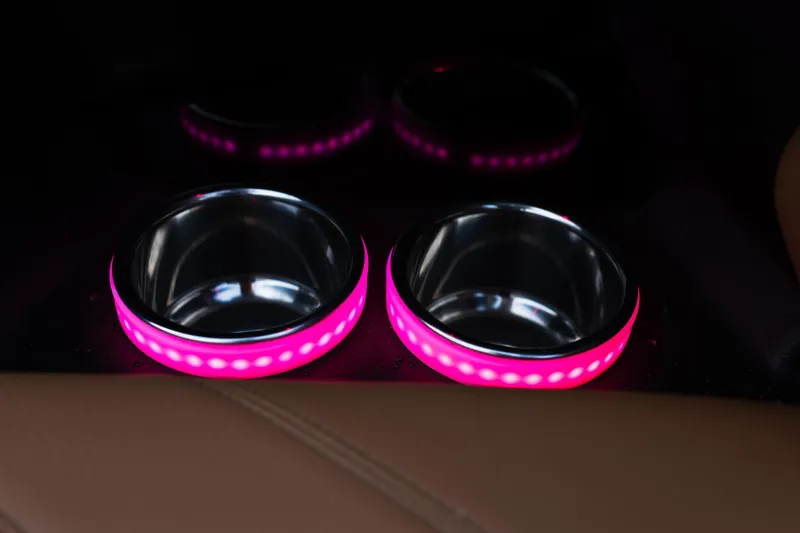 Slide: The Image of 2024 Supra SE illuminated cup holders with pink LED lighting. - 22