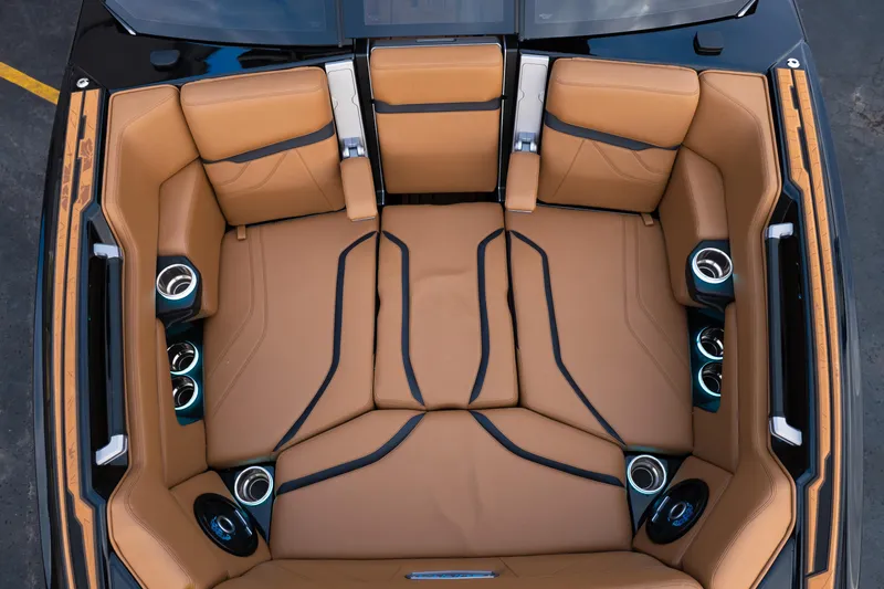 Slide: The Image of 2024 Supra SE interior with luxurious tan leather seating and integrated cup holders. - 23