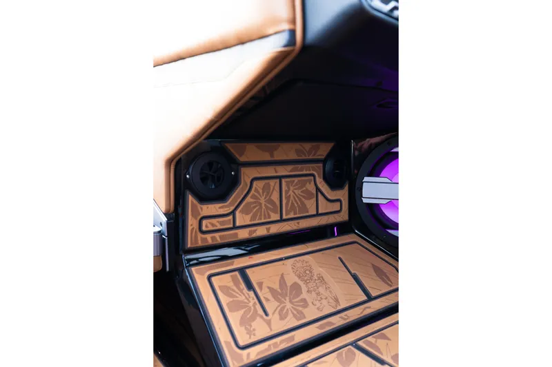 Slide: The Image of 2024 Supra SE interior with floral-patterned custom speaker panel and ambient lighting. - 27