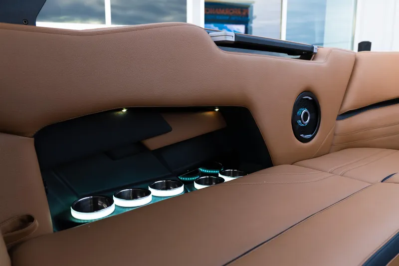 Slide: The Image of 2024 Supra SE interior with tan leather, illuminated cup holders, and speaker detail. - 31