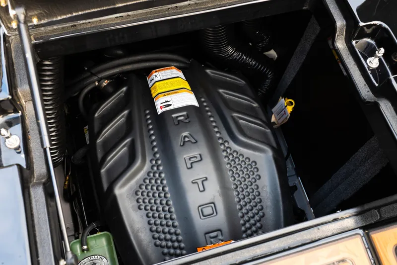 Slide: The Image of 2024 Supra SE engine compartment featuring a Raptor engine cover. - 36