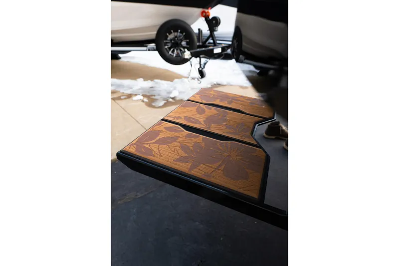 Slide: The Image of 2024 Supra SE boat platform with floral design, parked on snowy driveway. - 37