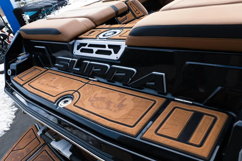 Slide: The Image of 2024 Supra SE boat with custom brown deck and seating, showcasing luxury design. - 38