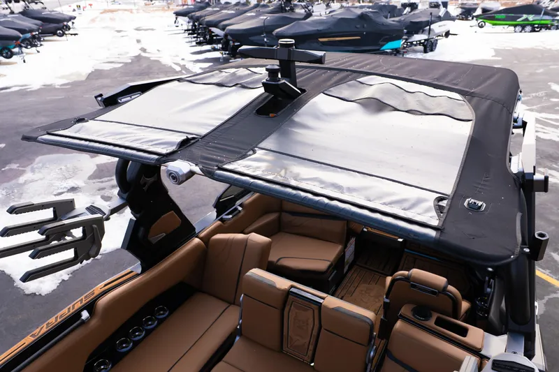 Slide: The Image of 2024 Supra SE boat with covered seating area, docked in snowy marina. - 41