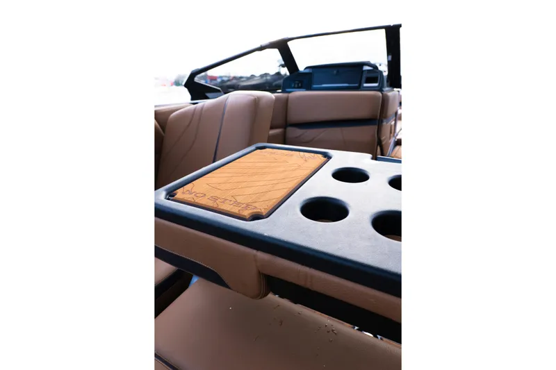 Slide: The Image of 2024 Supra SE interior with tan leather seats and cup holders. - 42