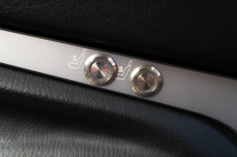 Slide: The Image of 2024 Supra SE seat adjustment buttons on black leather interior. - 48