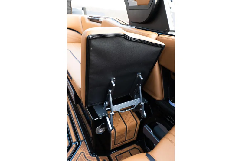 Slide: The Image of 2024 Supra SE interior with tan leather seats and foldable backrest mechanism. - 50