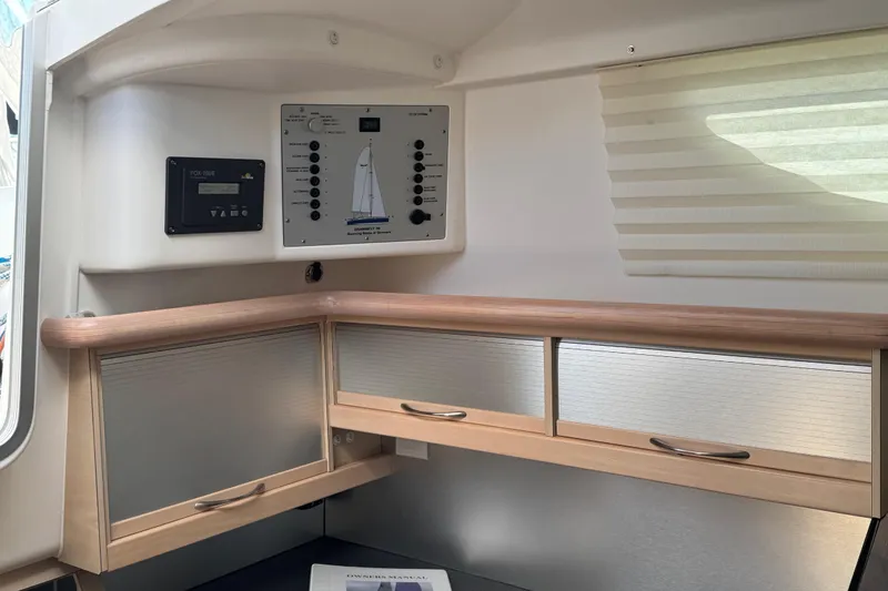 Slide: The Image of Interior of 2016 Dragonfly 32 sailboat with control panel and storage cabinets. - 13