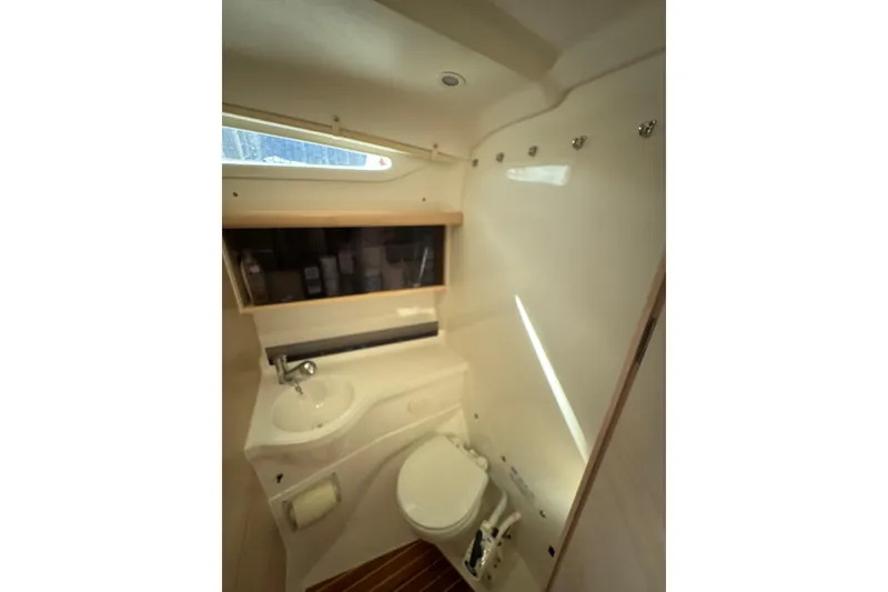 Slide: The Image of Compact bathroom in 2016 Dragonfly 32 sailboat with sink, toilet, and storage. - 17