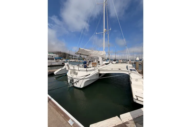 Slide: The Image of 2016 Dragonfly 32 sailboat docked in marina under clear blue sky. - 24