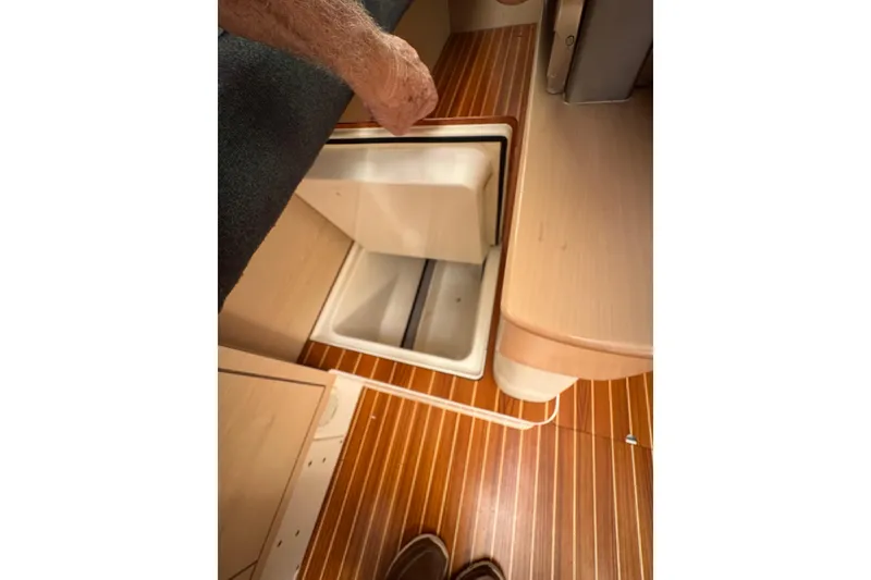 Slide: The Image of Interior view of 2016 Dragonfly 32 sailboat with open storage compartment. - 22