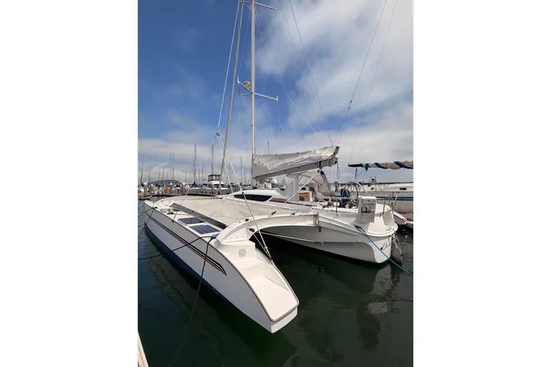 Slide: The Image of 2016 Dragonfly 32 trimaran docked at marina under clear blue sky. - 25