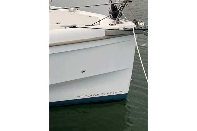 Slide: The Image of Bow of a 2016 Dragonfly 32 Touring sailboat on calm water. - 23