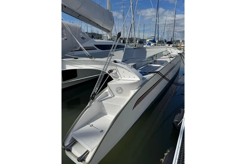 Slide: The Image of 2016 Dragonfly 32 sailboat docked in marina, featuring sleek design and modern rigging. - 9