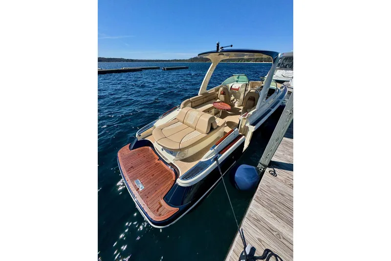 Slide: The Image of 2019 Chris-Craft Launch 28 GT boat docked on a sunny day, showcasing luxury seating and design. - 1