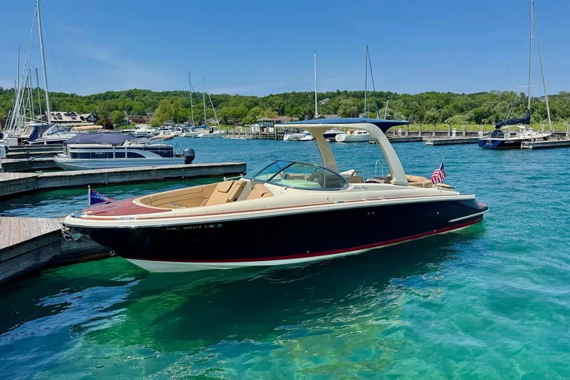 Slide: The Image of 2019 Chris-Craft Launch 28 GT boat docked in a scenic marina. - 10