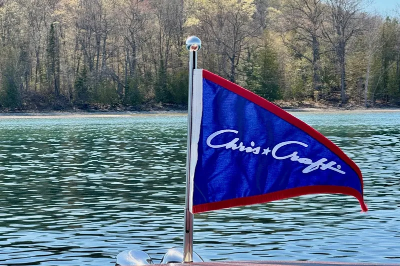 Slide: The Image of 2019 Chris-Craft Launch 28 GT flag on a serene lake backdrop. - 3
