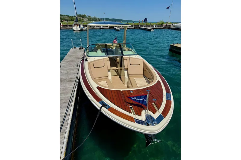 Slide: The Image of 2019 Chris-Craft Launch 28 GT docked, showcasing elegant design and luxurious seating. - 4