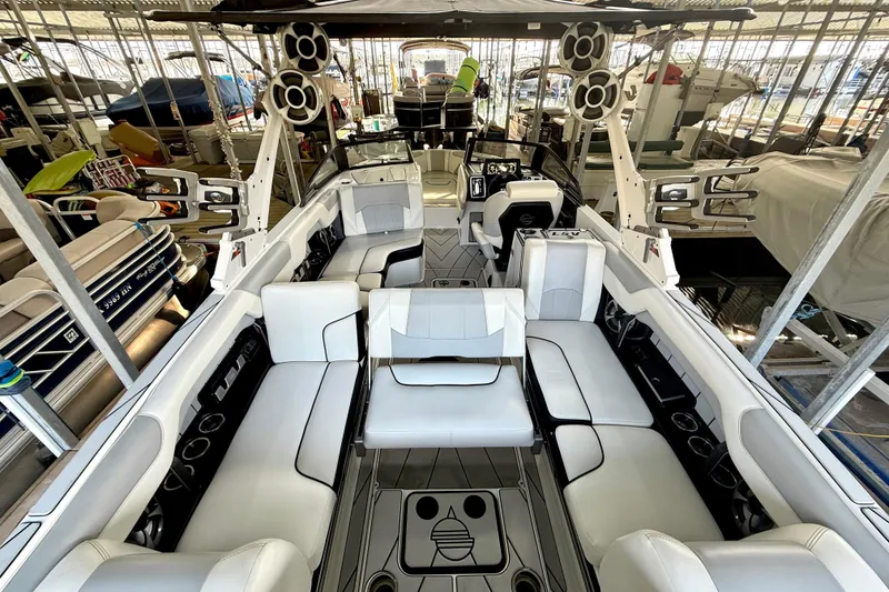 Slide: The Image of 2021 Malibu Wakesetter 25 LSV boat interior with luxurious seating and advanced audio system. - 17