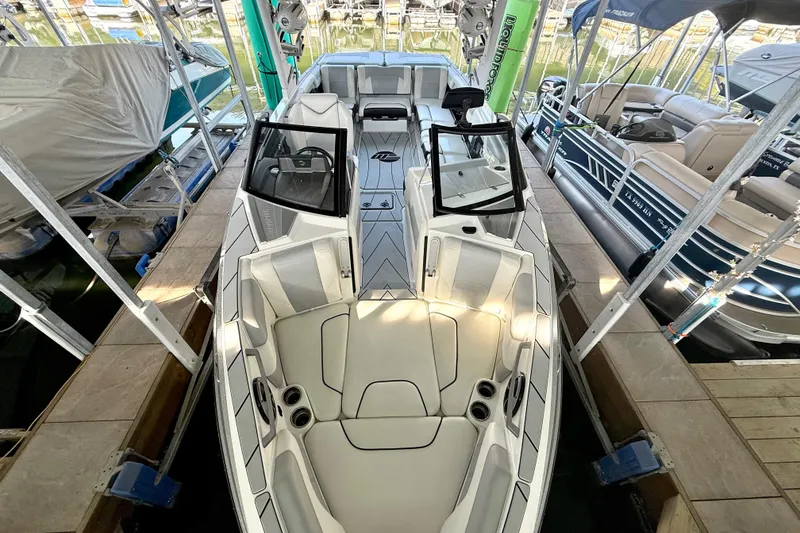 Slide: The Image of 2021 Malibu Wakesetter 25 LSV boat docked, showcasing sleek design and spacious seating. - 18