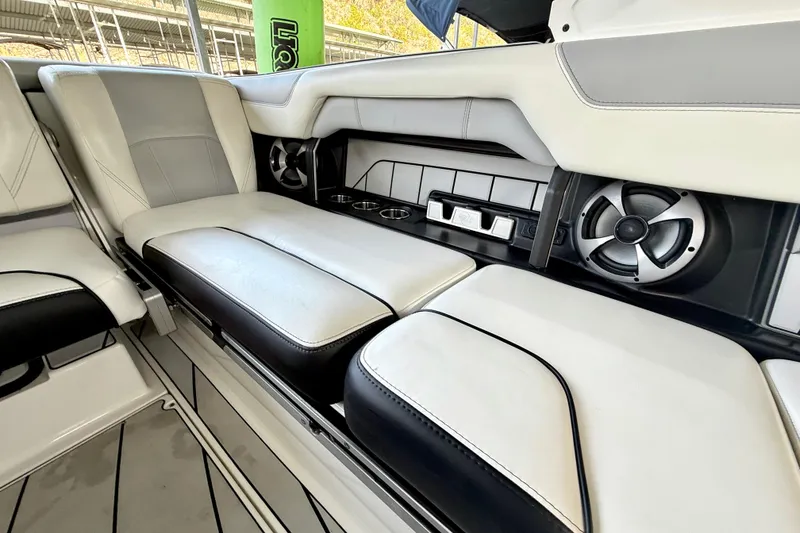 Slide: The Image of 2021 Malibu Wakesetter 25 LSV interior with plush seating and built-in speakers. - 20