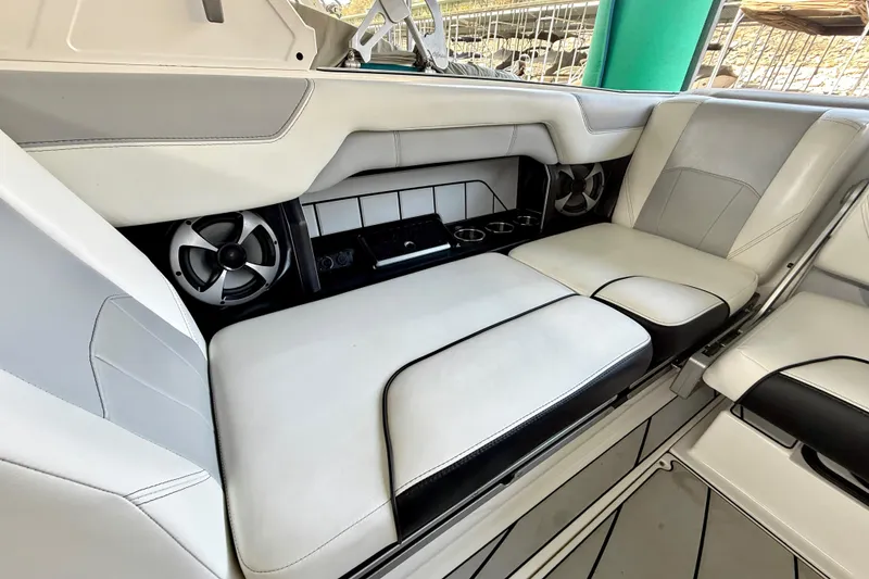 Slide: The Image of 2021 Malibu Wakesetter 25 LSV interior with white leather seating and built-in speakers. - 21