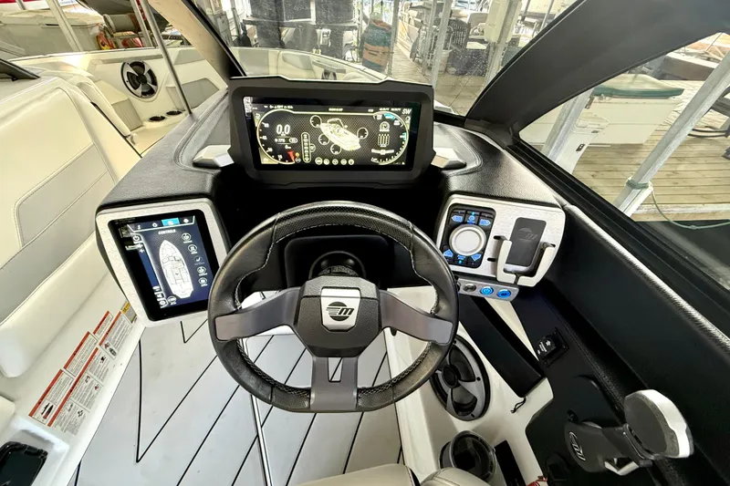 Slide: The Image of 2021 Malibu Wakesetter 25 LSV dashboard with advanced digital controls and steering wheel. - 23