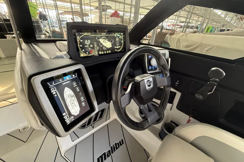 Slide: The Image of 2021 Malibu Wakesetter 25 LSV dashboard with advanced digital controls and steering wheel. - 24