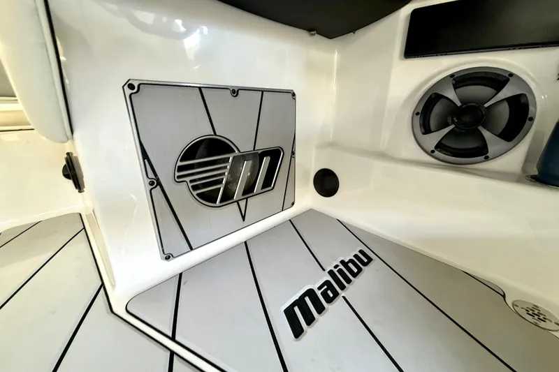 Slide: The Image of 2021 Malibu Wakesetter 25 LSV interior with logo and speaker detail. - 25