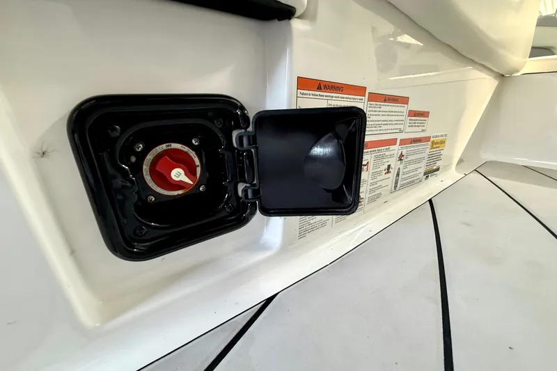 Slide: The Image of 2021 Malibu Wakesetter 25 LSV battery switch and warning labels on deck. - 26