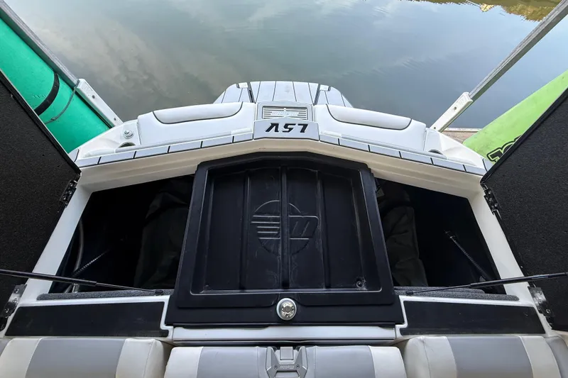 Slide: The Image of 2021 Malibu Wakesetter 25 LSV boat storage compartment open by the water. - 30