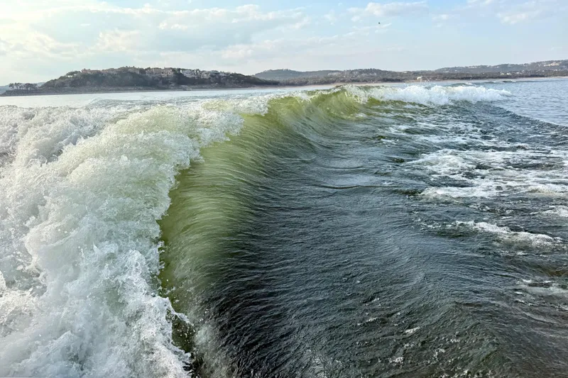 Slide: The Image of Wakesurfing wave created by 2021 Malibu Wakesetter 25 LSV on a scenic lake. - 36